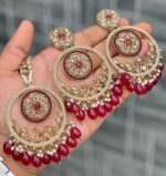 Beautiful premium quality reverse Ad Burgundy coloured artificial stone, pearl earrings and tilak made of base metal alloy and gold plated and presented in hand holding